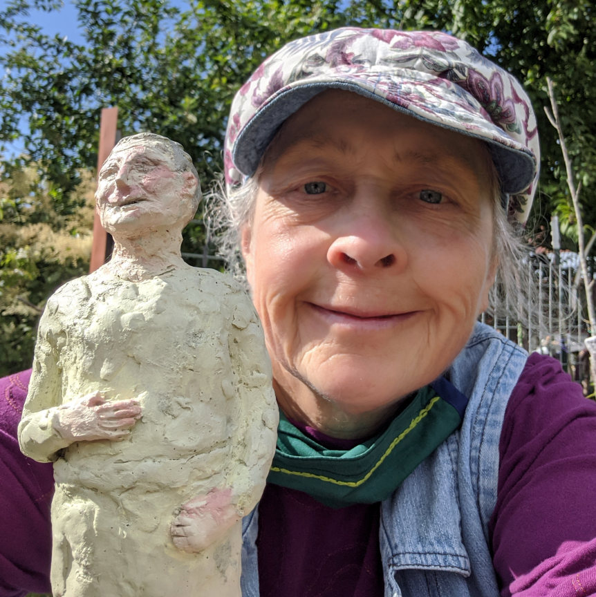 Photo of artist with cement sculpture